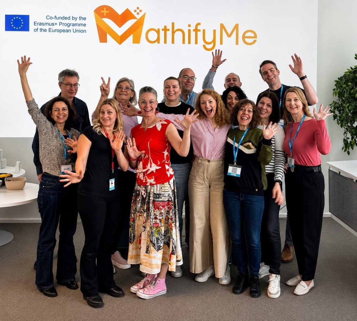 MathifyMe project partners waving in front of the MathifyMe logo during the Mid-Term Meeting in Pori, Finland.